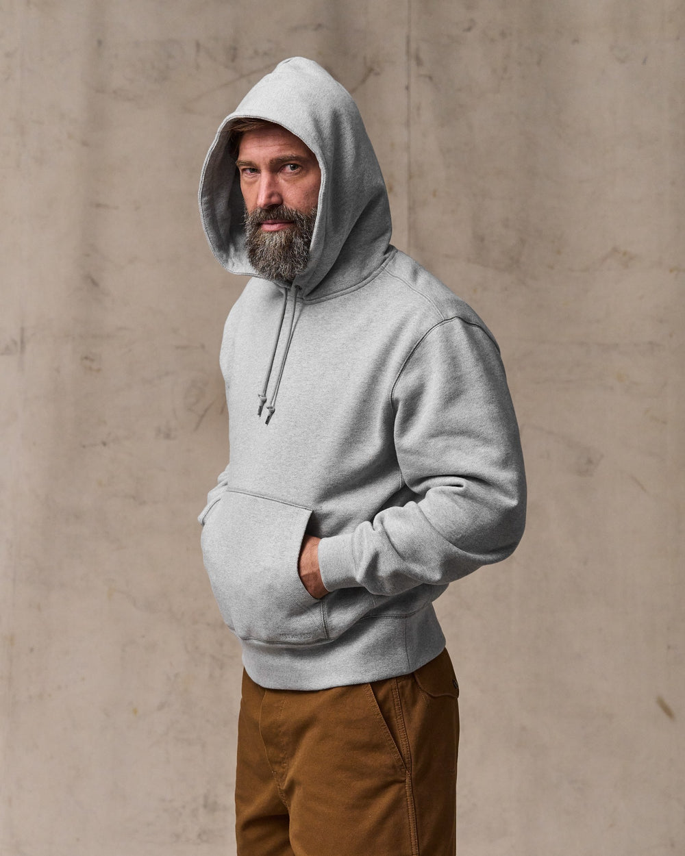 image of a model wearing Filson's 14-oz. Heritage Fleece Hoodie - Gray Heather