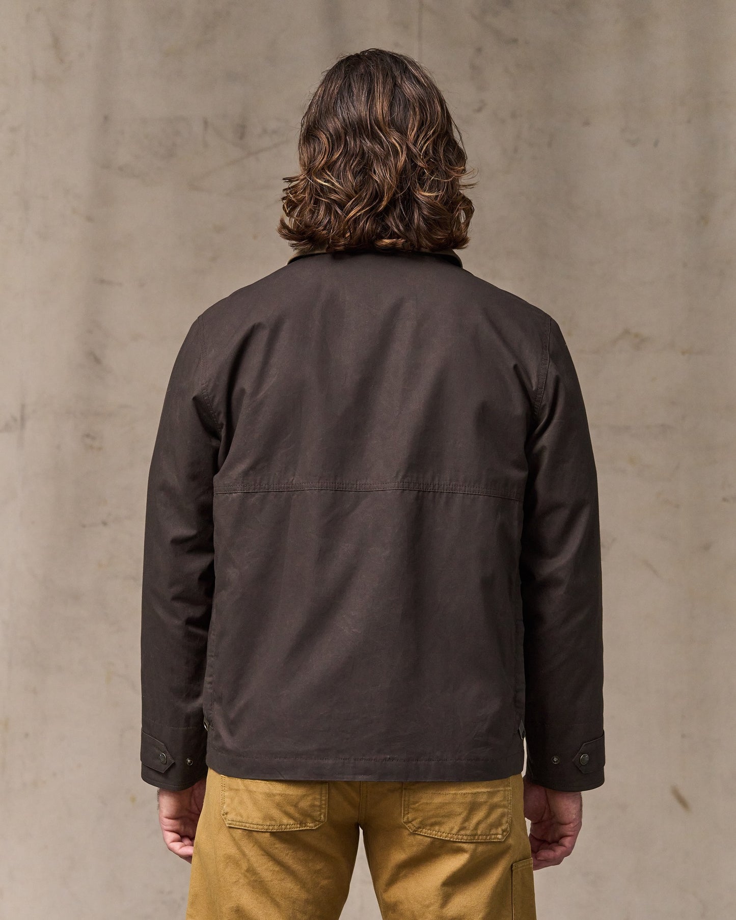 image of a model wearing Filson's Dry Wax Short Field Jacket - Dark Brown