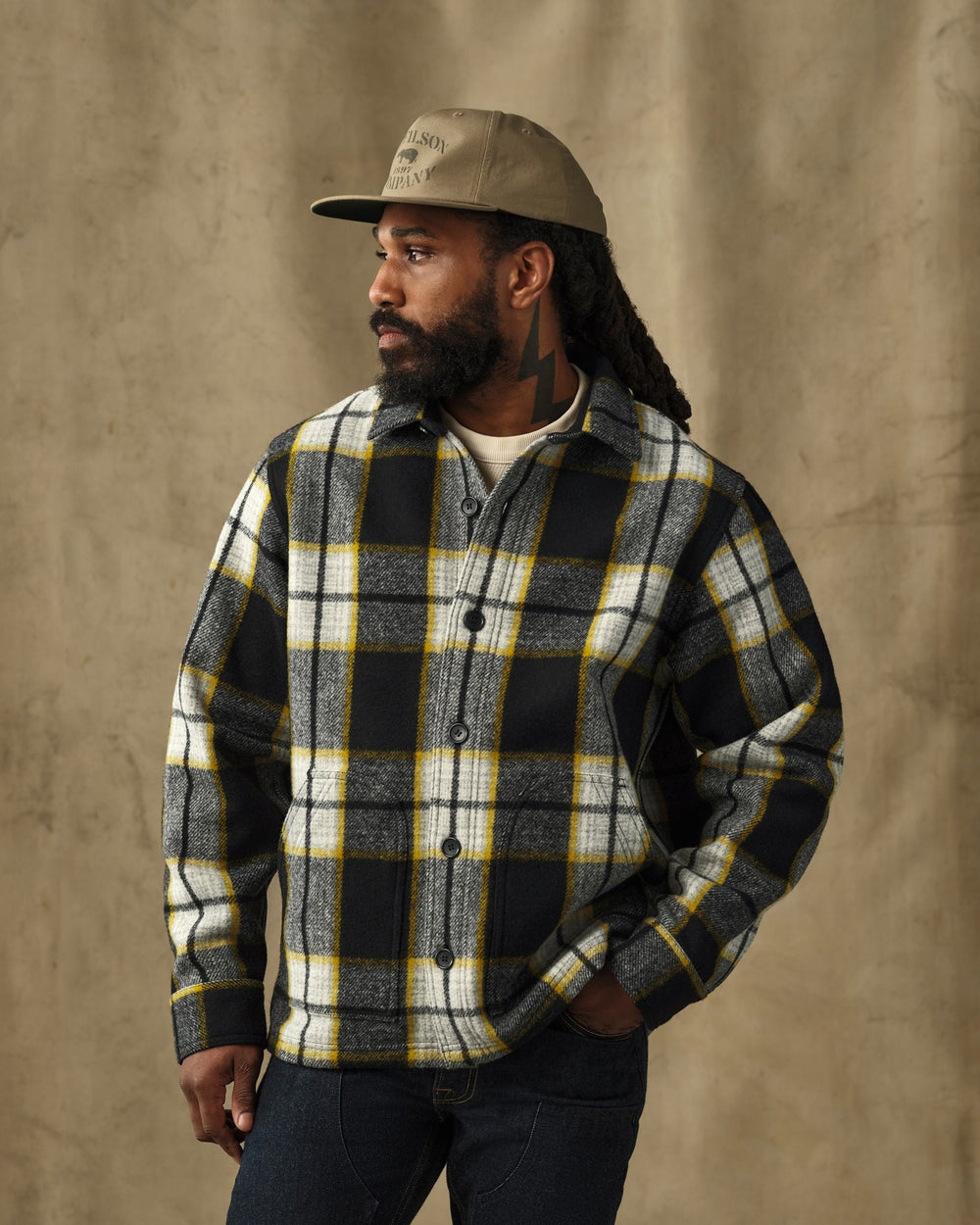 image of a model wearing Filson's Mackinaw Wool 1972 Coat - Black / Yellow Plaid