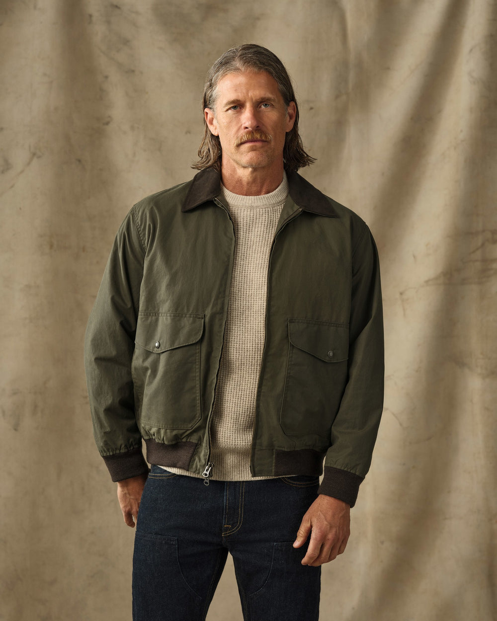 image of a model wearing Filson's Cover Cloth Bomber Jacket - Marsh Olive