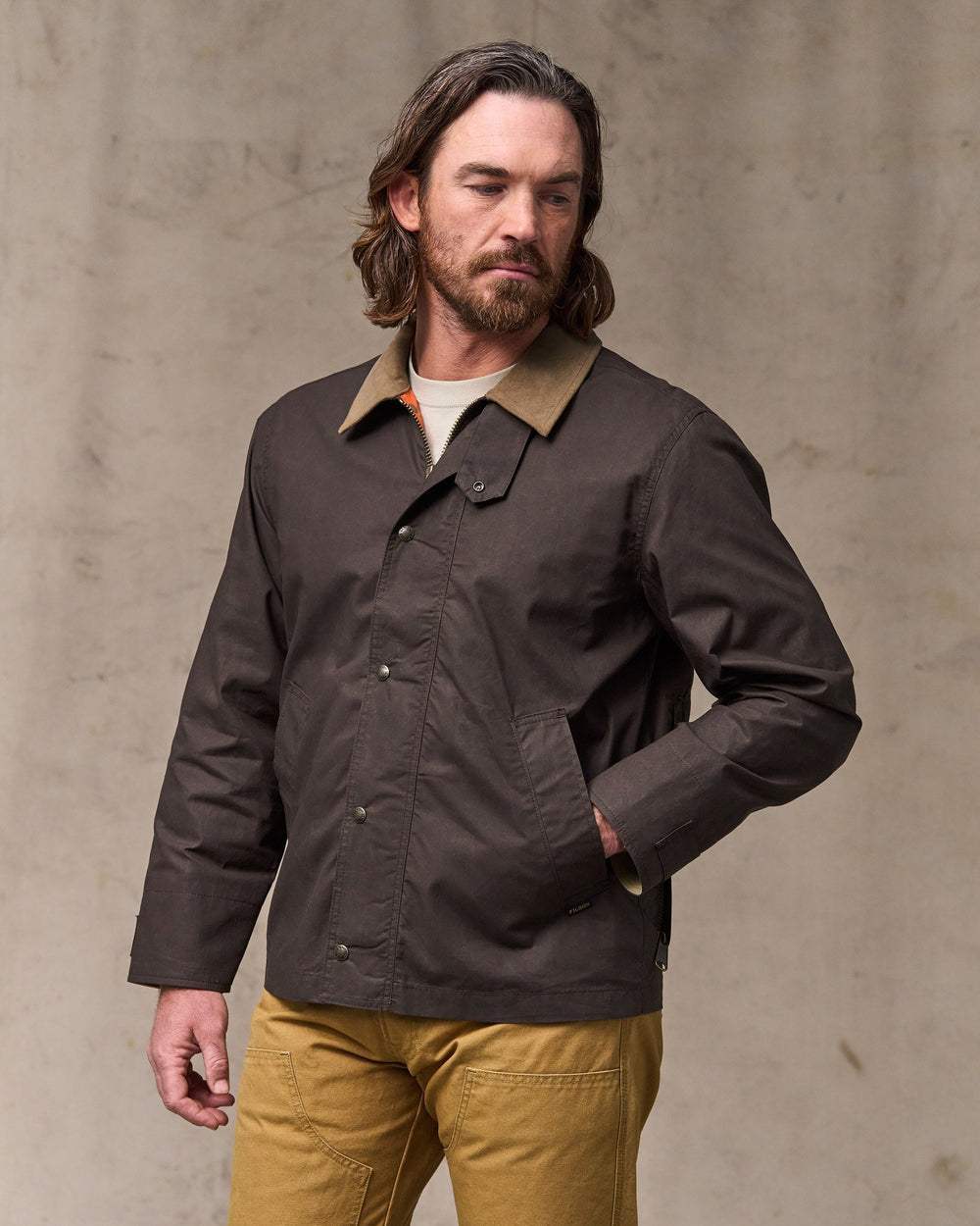 image of a model wearing Filson's Dry Wax Short Field Jacket - Dark Brown
