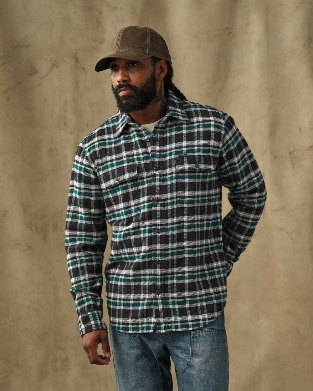 image of a model wearing Filson's Vintage Flannel Work Shirt - Black / Green Plaid