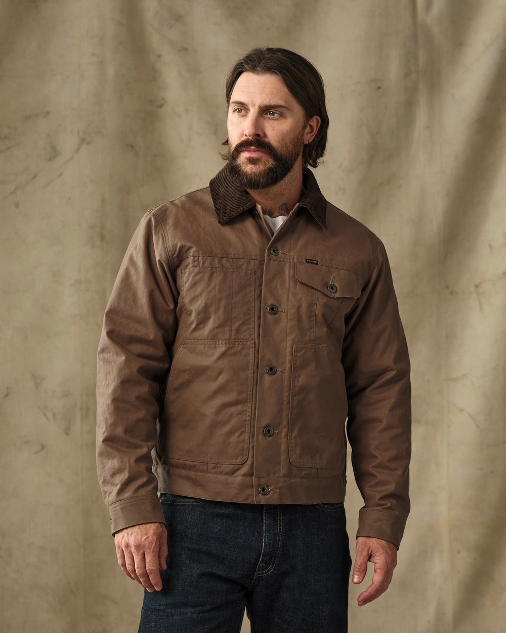 image of a model wearing Filson's Insulated Short Cruiser Jacket - Dark Brown