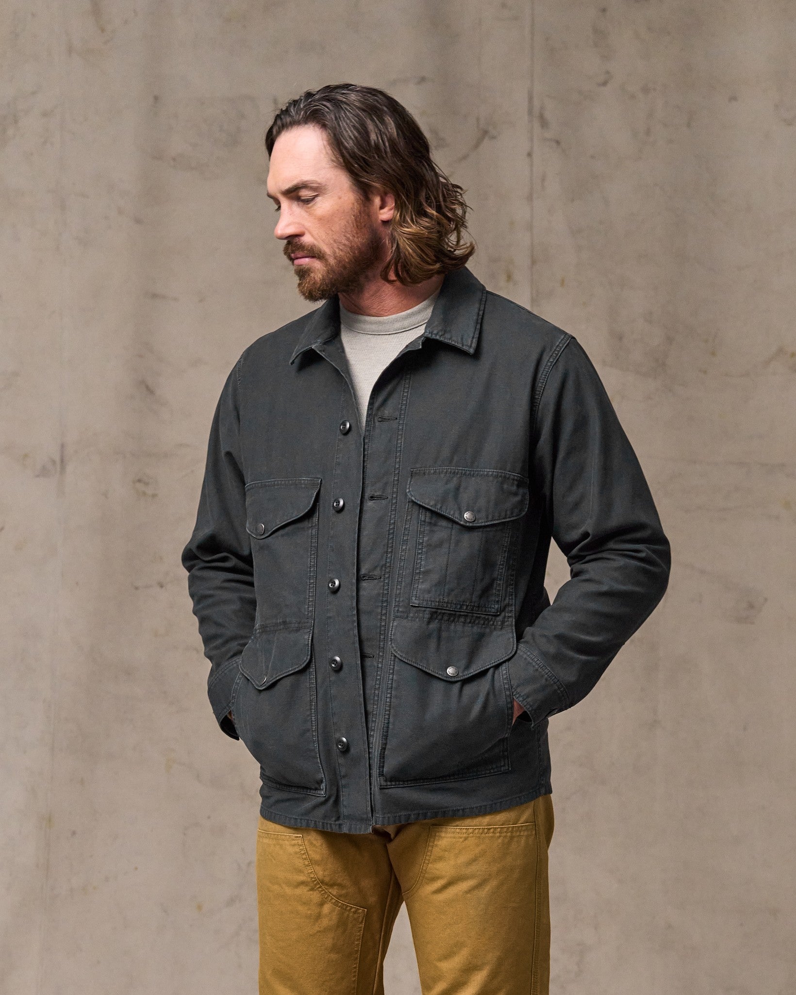 image of a model wearing Filson's Field Cruiser Jacket - Washed Faded Black