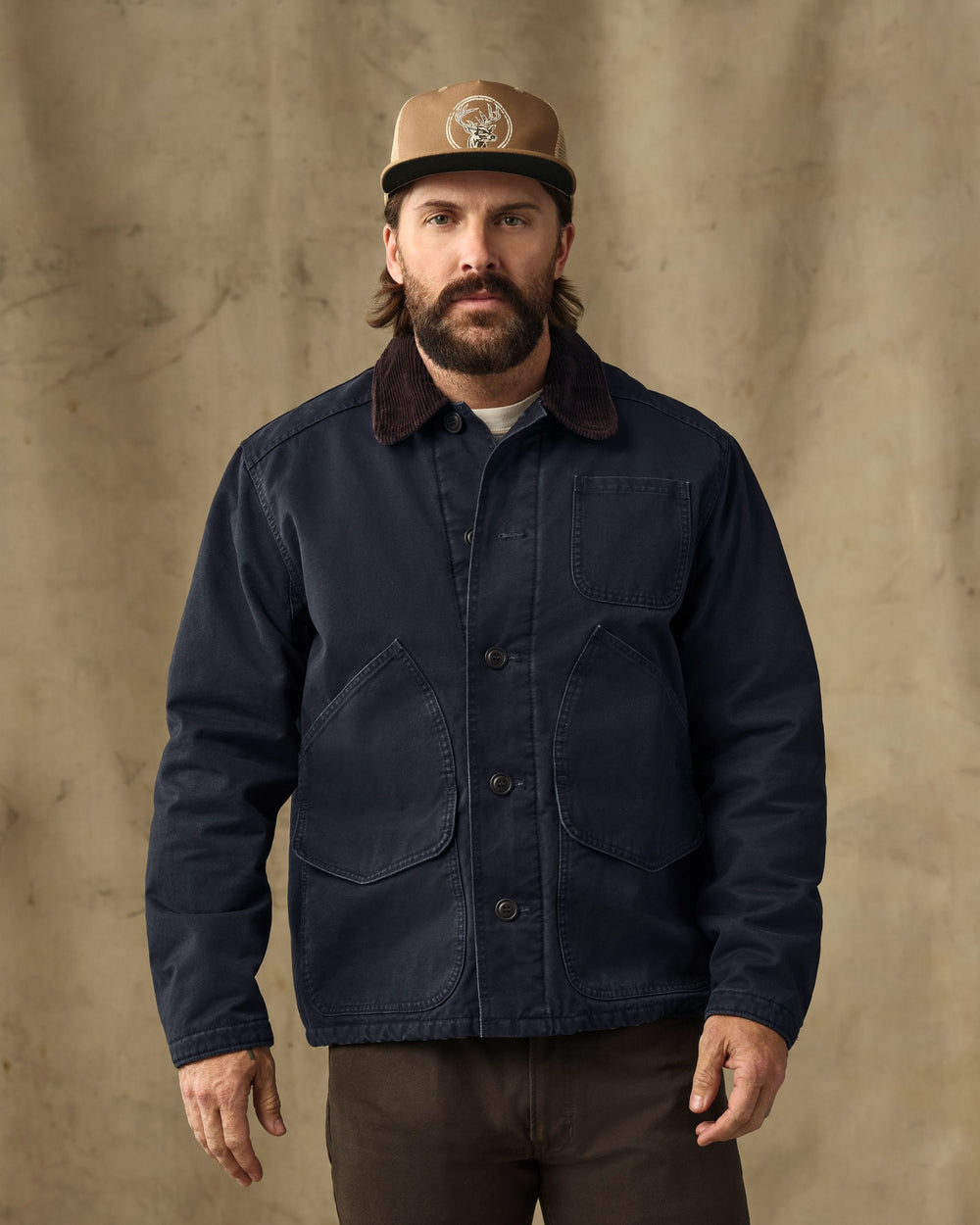 image of a model wearing Filson's Insulated Canvas Outfitter Jacket - Dark Navy