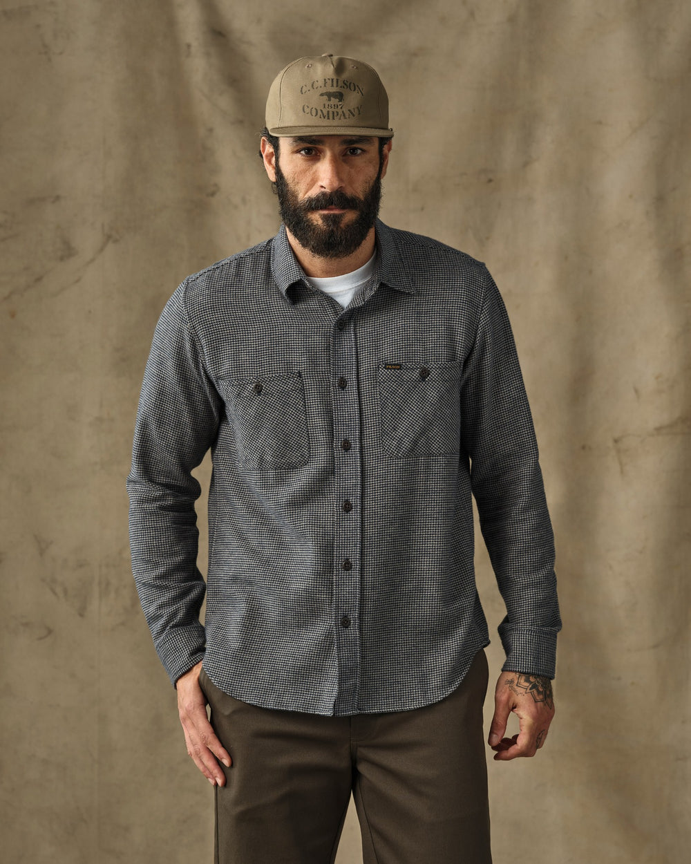 image of a model wearing Filson's Rangeland Flannel Shirt - Navy / Tan Plaid