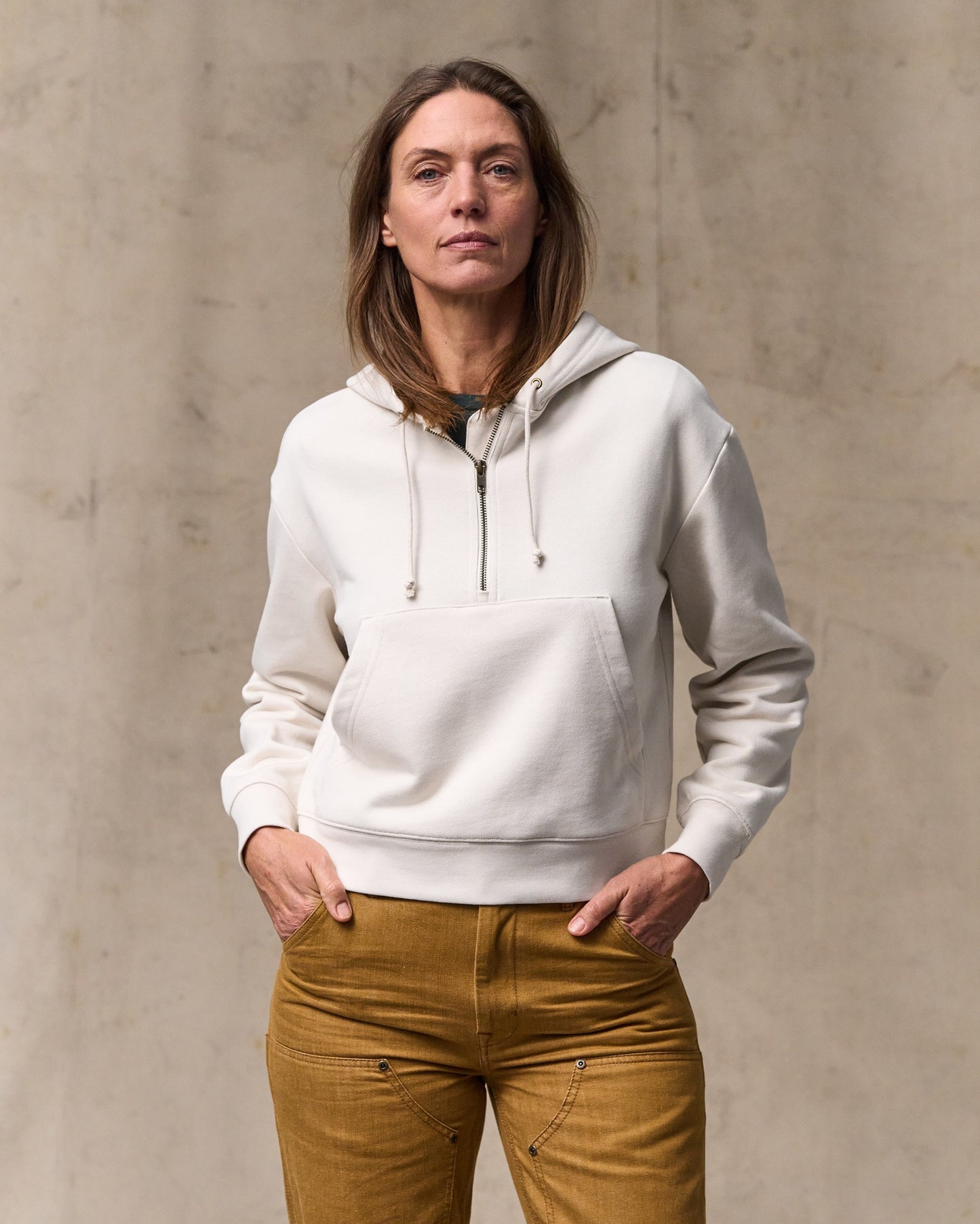 image of a model wearing Filson's Women's French Terry Half-zip Hoodie - Ivory|Model is 5'10" wearing a size medium|Model is 5'10" wearing a size medium