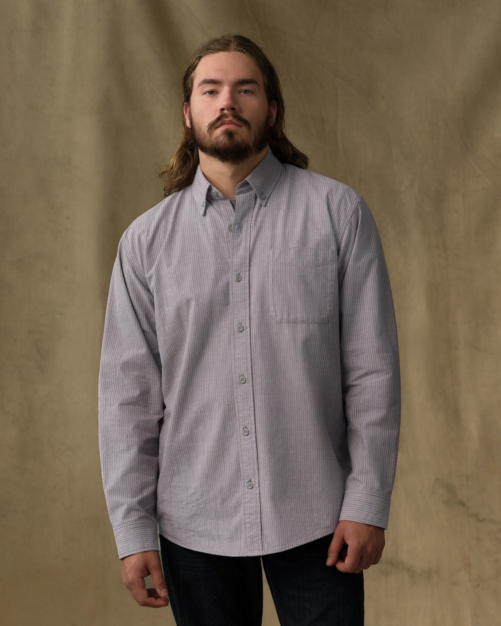 image of a model wearing Filson's Chambray Button-Down Shirt - Vintage Gray Stripe