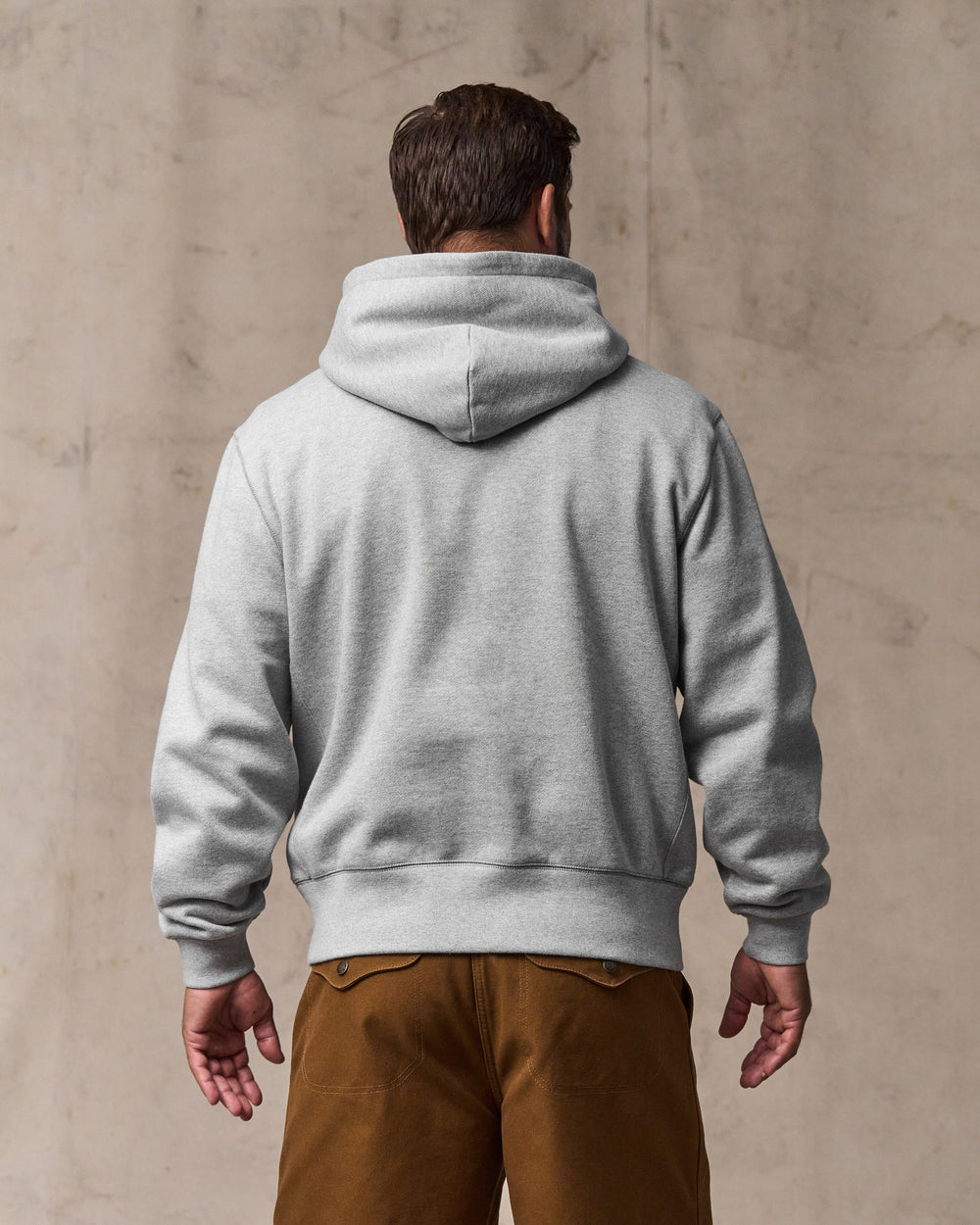 image of a model wearing Filson's 14-oz. Heritage Fleece Hoodie - Gray Heather