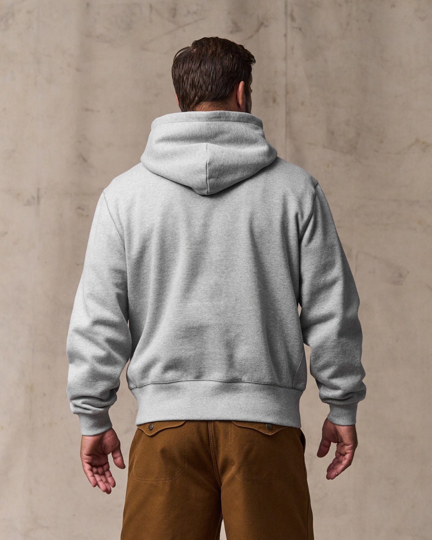 image of a model wearing Filson's 14-oz. Heritage Fleece Hoodie - Gray Heather