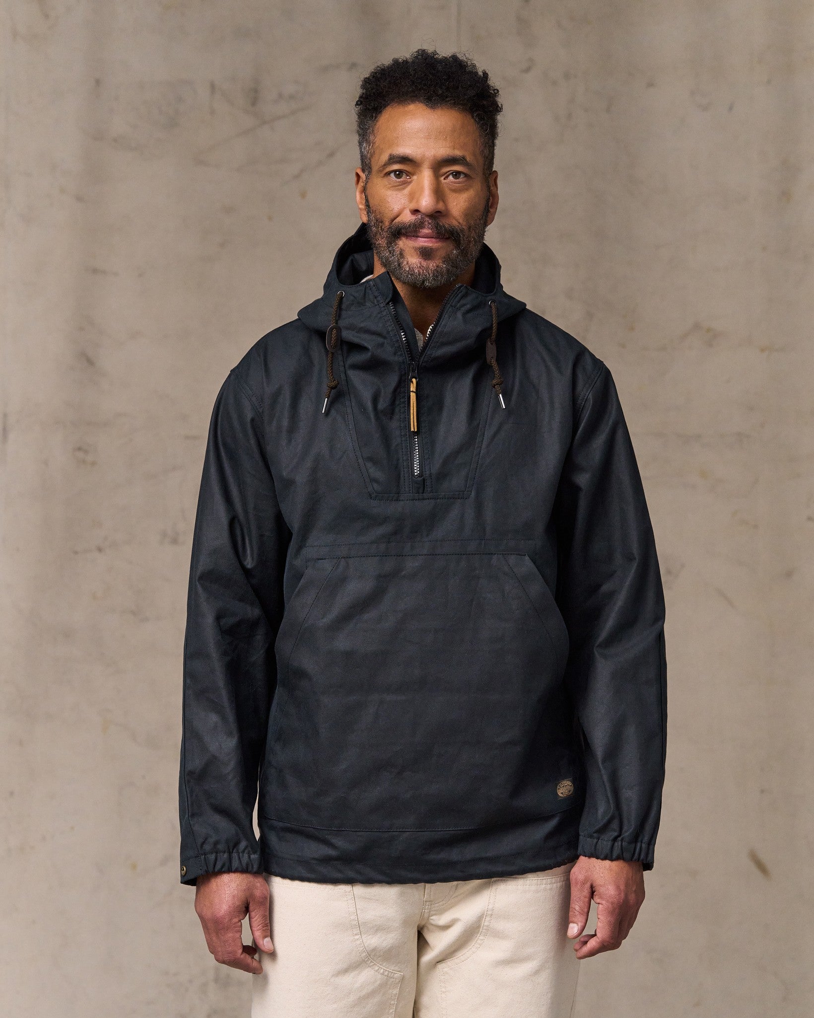 image of a model wearing Filson's Shelter Cloth Waxed Anorak - Harbor Blue