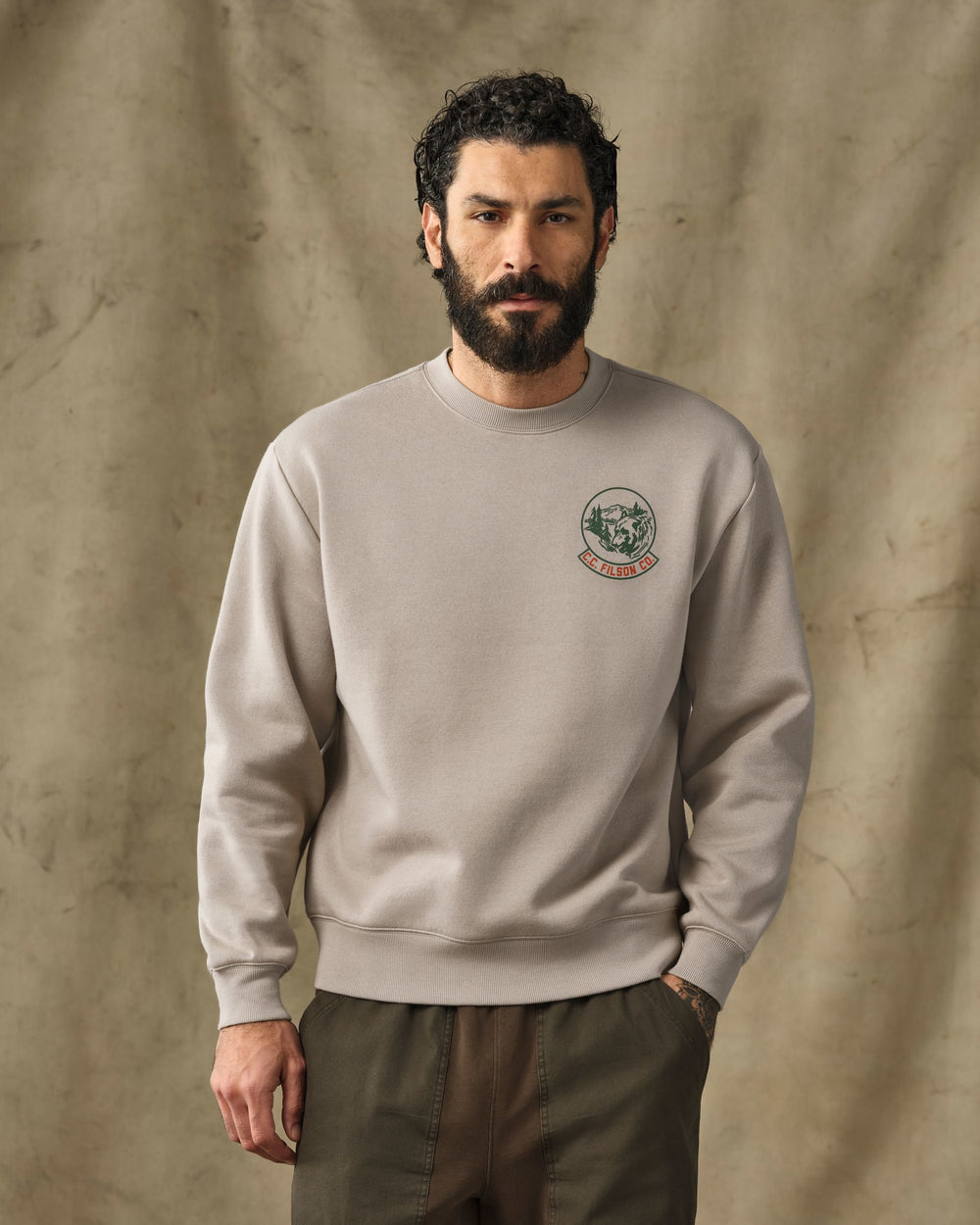 image of a model wearing Filson's Bear Graphic Crewneck Sweatshirt - Vintage Khaki