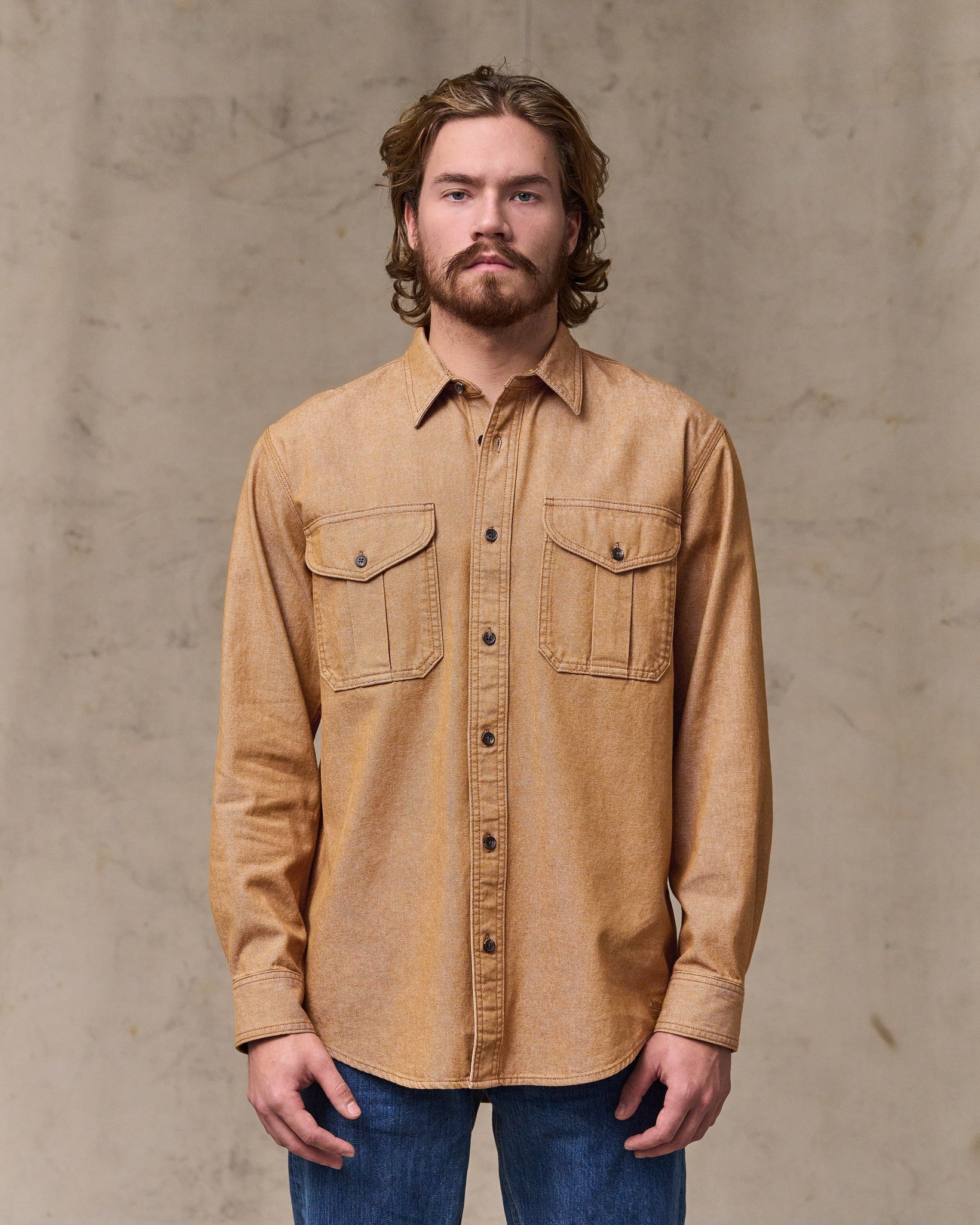 image of a model wearing Filson's Denim Guide Shirt - Harvest Tan