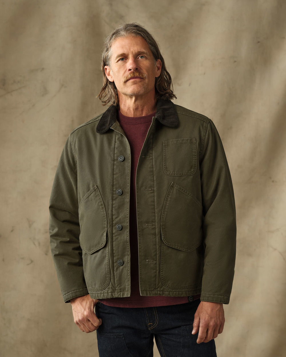 image of a model wearing Filson's Insulated Canvas Outfitter Jacket - Dark Olive