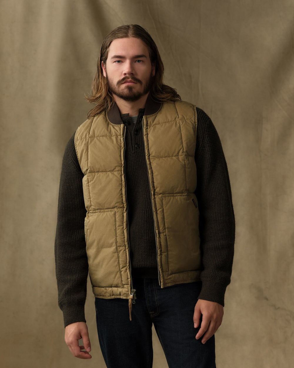 image of a model wearing Filson's Heritage Cotton Down Vest - Light Brown