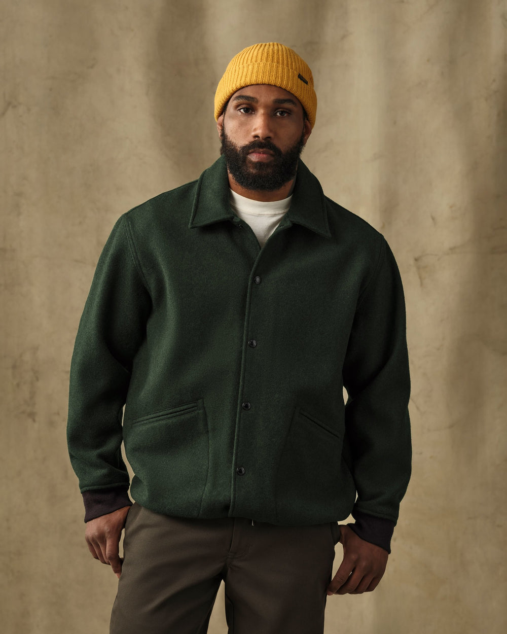 image of a model wearing Filson's Mackinaw Wool Coach Jacket - Vintage Pine