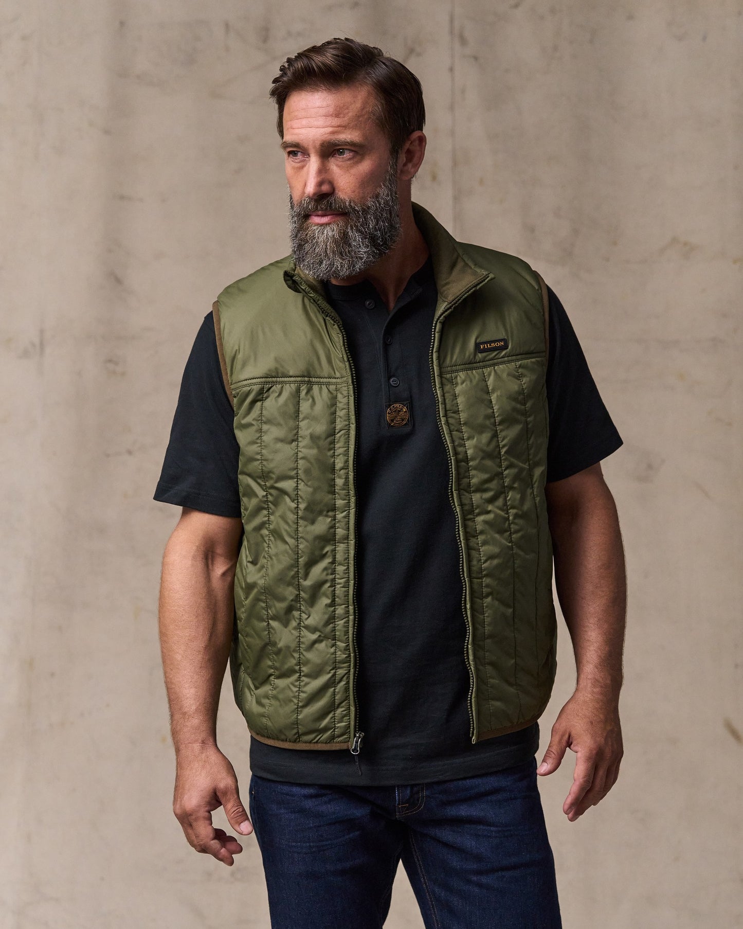 image of a model wearing Filson's Ultralight Vest - Dark Olive Drab|Model is 6'1" wearing a size medium